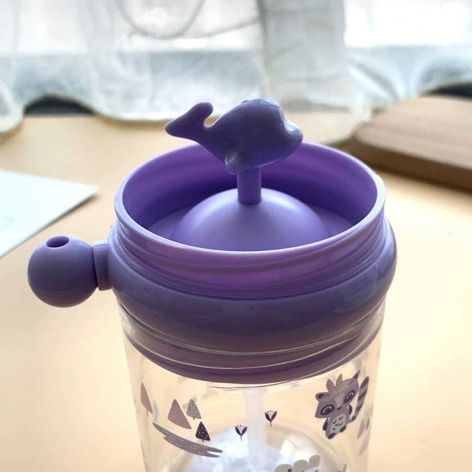 Spill-proof sippy cup with fun whale design.