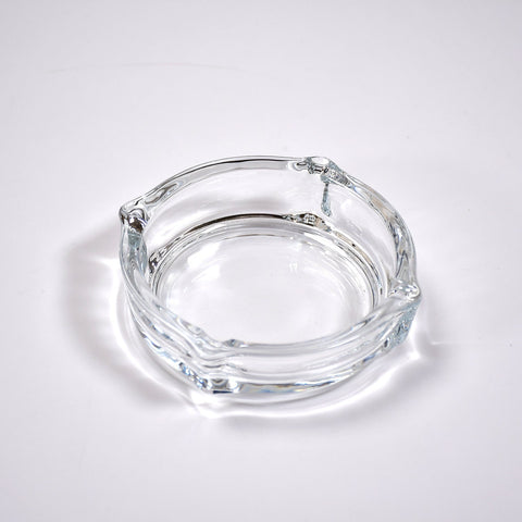 Glass ashtray with round design.